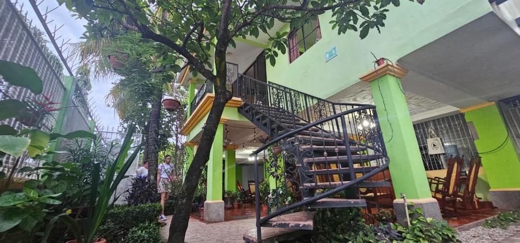 a building with a spiral staircase in a garden at Hostal San Antonio in León