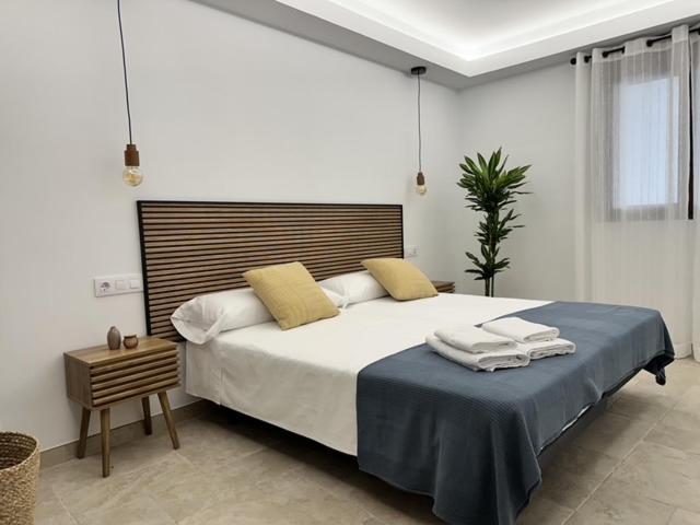 a bedroom with a large bed with towels on it at Las Casillas de Laujar in Laujar de Andarax