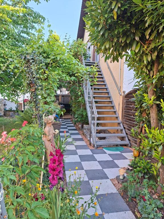 a garden with a checkered walkway in front of a building at Ferienwohnung Gersch in Wolf