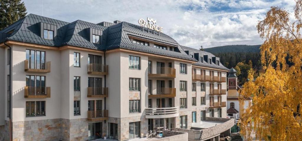 a large building with a black roof at Palace Apartments in Špindlerův Mlýn