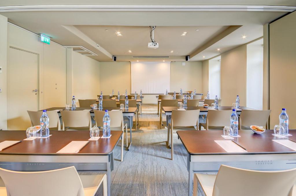 A conference room arranged in rows with a projection screen at the front.