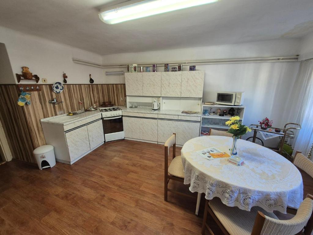 a kitchen with a table with a vase of flowers on it at Privat Anna in Loket