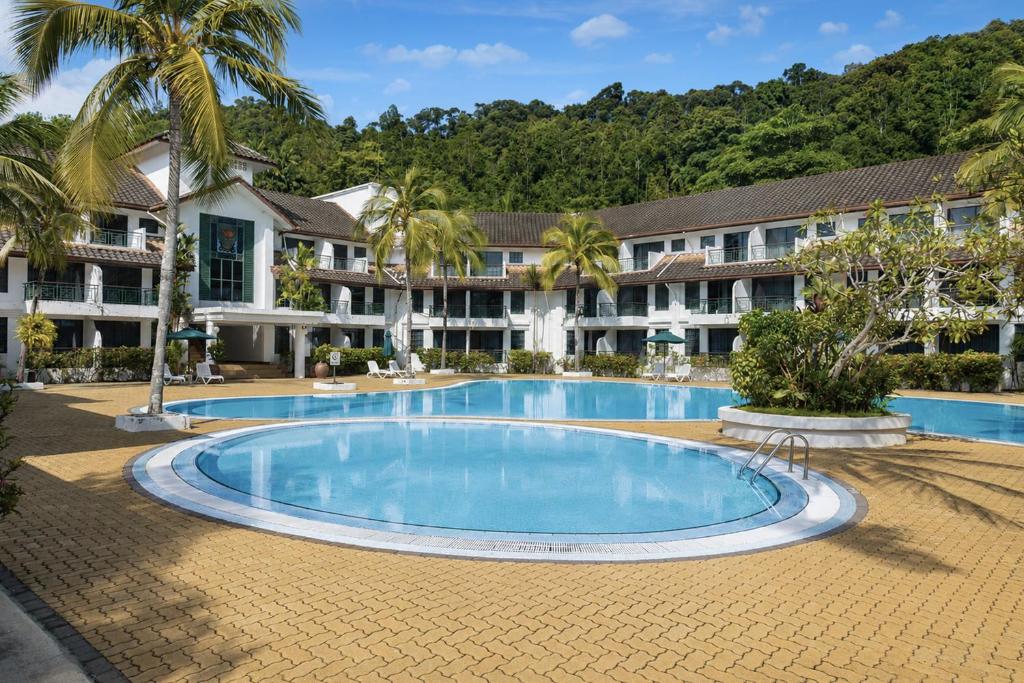 a swimming pool in front of a resort at Sunday Residence Inn Cherating in Cherating