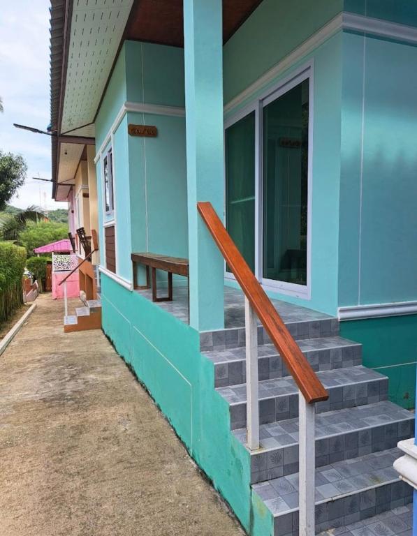 a house with blue paint and stairs outside at Baan Ton Pai in Ko Yao Noi