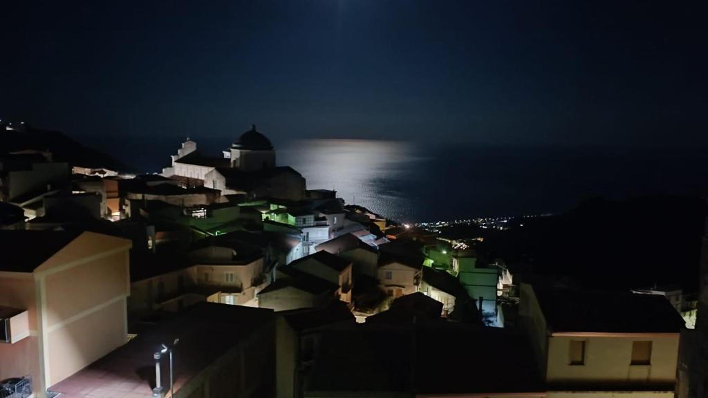 a view of a city at night at casa la terrazza sul mare in Alì