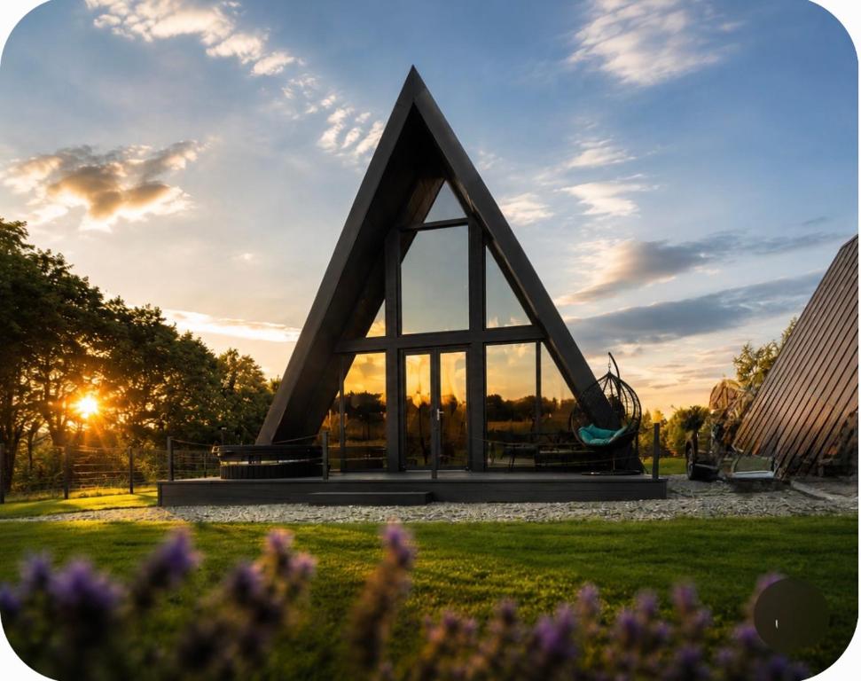 a pyramid shaped monument in a park with flowers at Devi retreat in Arpaşu de Sus