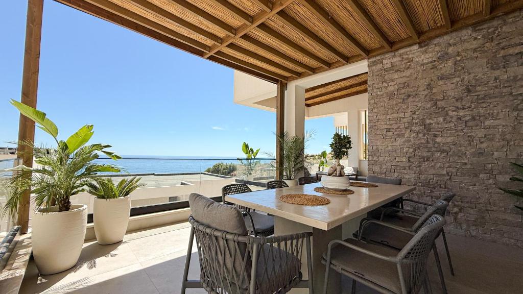 a dining room with a table and chairs at Villa 4 - Drymades - Thymus Residence in Dhërmi