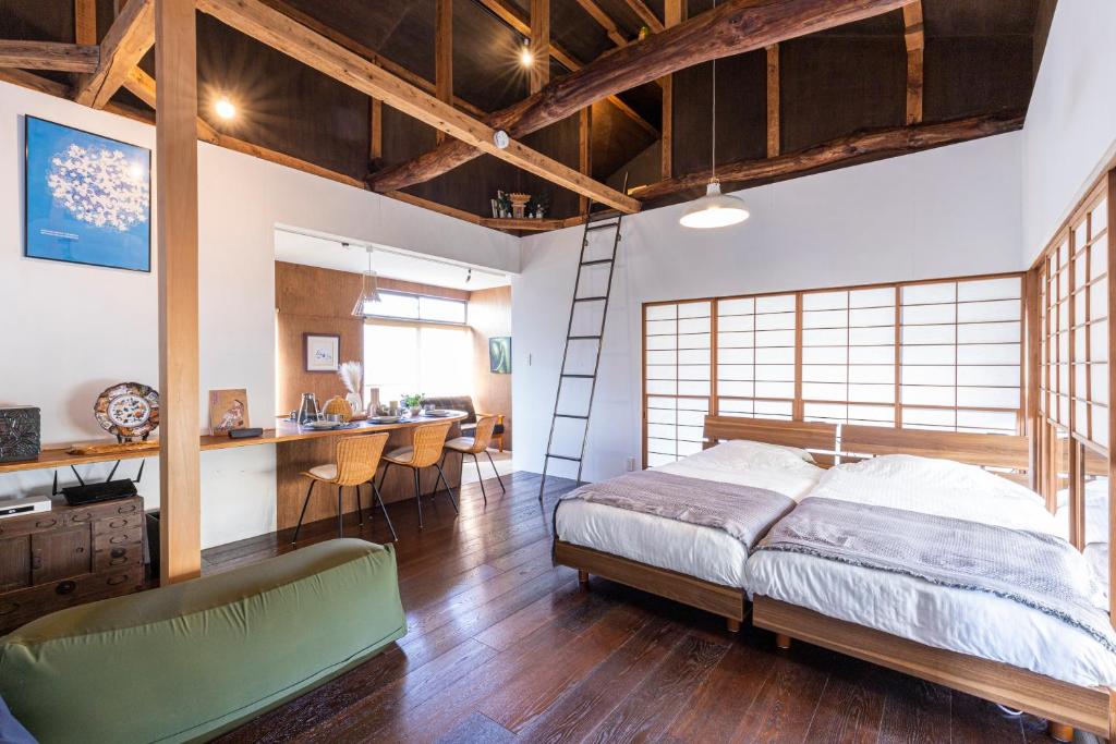 a bedroom with a bed and a desk in it at Takeno-an in Mitaka