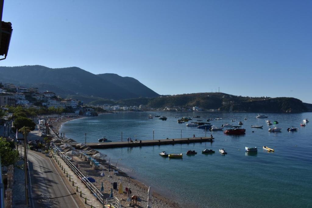 a group of boats in the water on a beach at Ionian Balcony in Himare