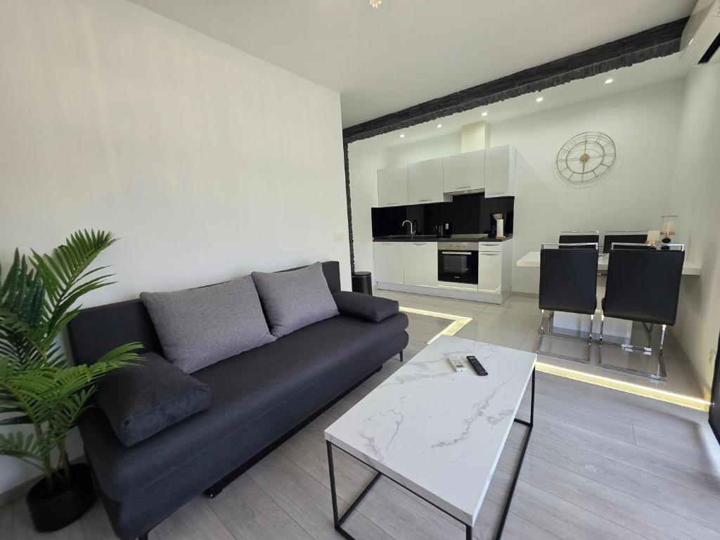 a living room with a couch and a table at Apartments Taratta 1 in Trogir