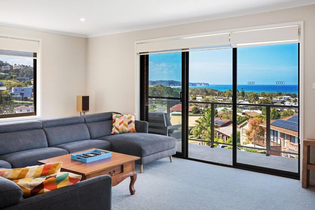 a living room with a couch and a table at Seaside Escape in Tathra