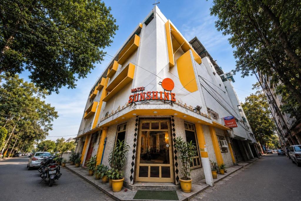 a yellow and white building on a street at Hotel Sunshine - Karol Bagh Budget Stay at New Delhi in New Delhi