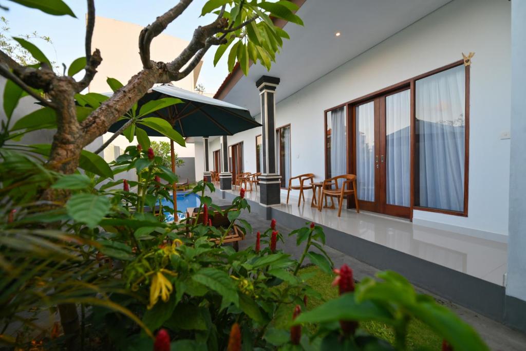 a view of a house with a garden and a patio at Villa Raksa Canggu in Canggu