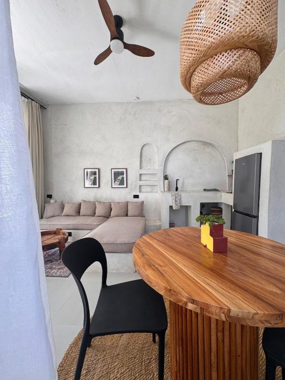 a living room with a table and a couch at Casa Mysa Villas in Michamvi