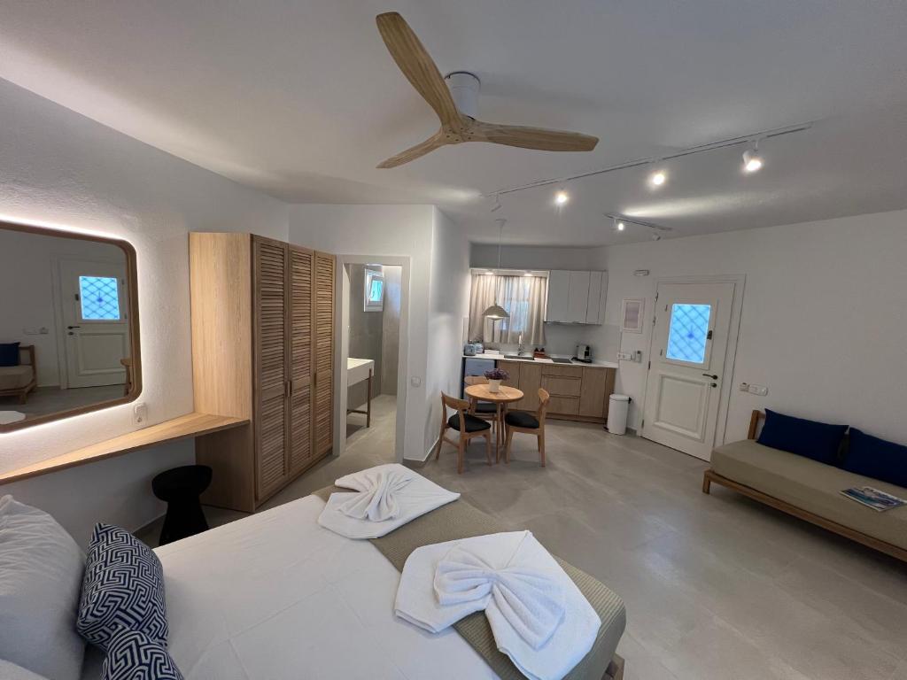 a bedroom with a bed and a living room at Villa Fantasia in Skiathos
