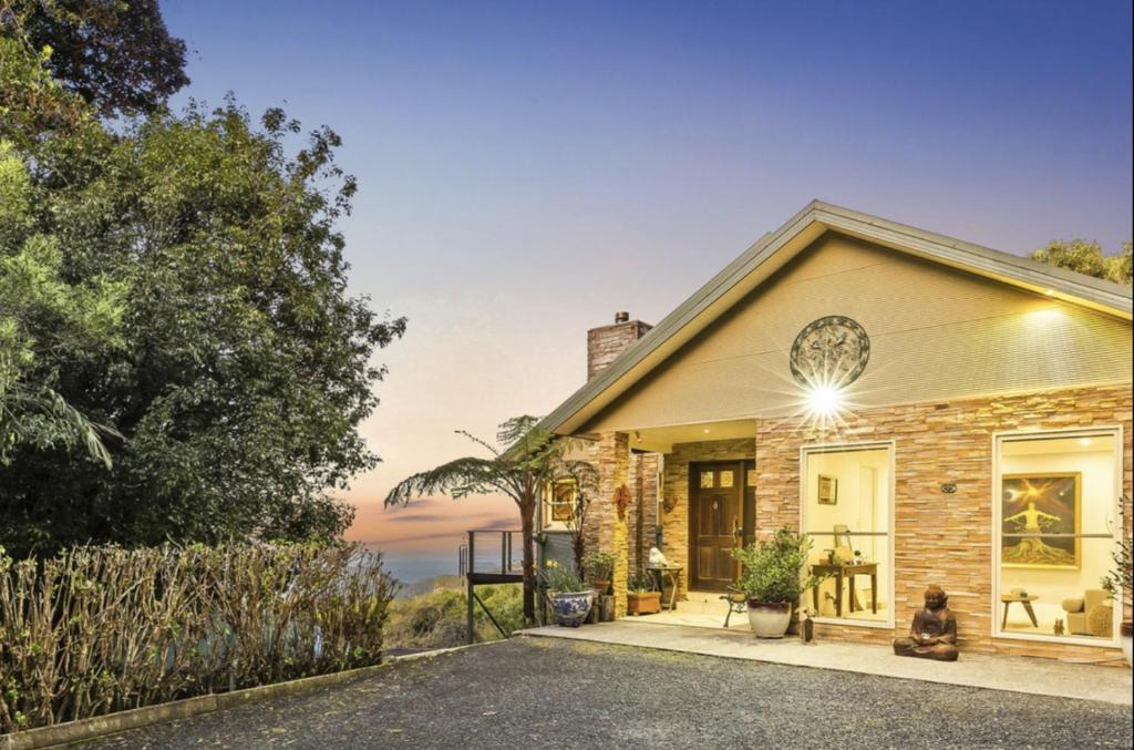 a house with a view of the ocean at Serenity Rainforest Retreat With Breathtaking Gold Coast Views - Sleeps 4 - 6 people in Springbrook