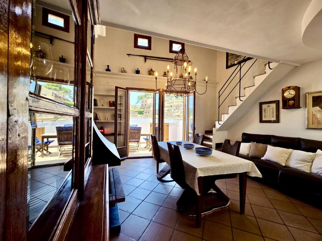 a living room with a table and a couch at EVH137 Can Biel in Tossa de Mar