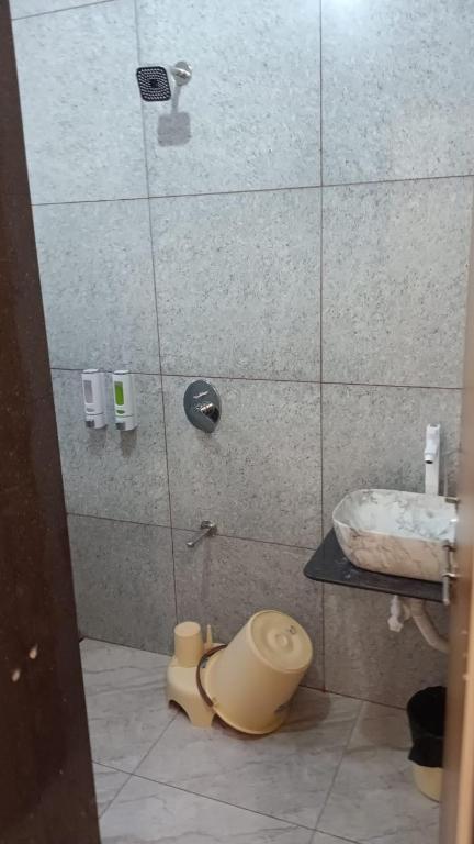 a bathroom with a shower with a toilet and a sink at Hotel Dwarkesh in Dwarka