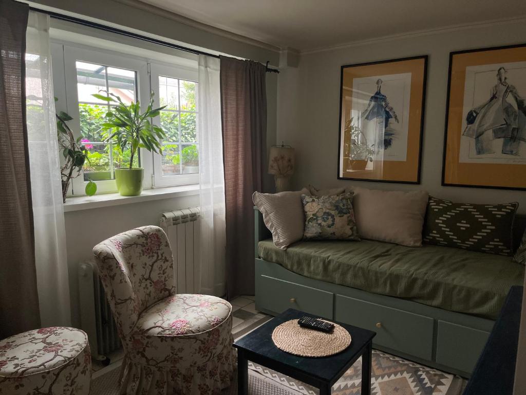 a living room with a couch and two chairs at Magnolia Nest in Belgrade