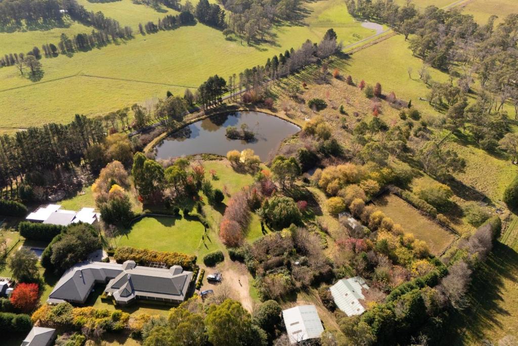 an aerial view of a house and a lake at Wayside Zenhill Retreat Bowral Event & Farm in Glenquarry