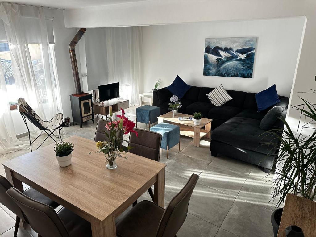 a living room with a couch and a table at Arsenia Cottage D - Kyperounta in Kyperounda