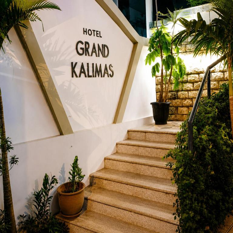 a set of stairs with a sign that reads hotel grand klins at Grand Kalimas Hotel in Surabaya