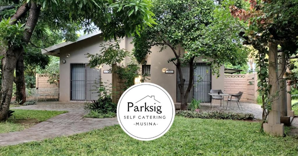 a sign in a yard in front of a house at Parksig Self Catering in Musina