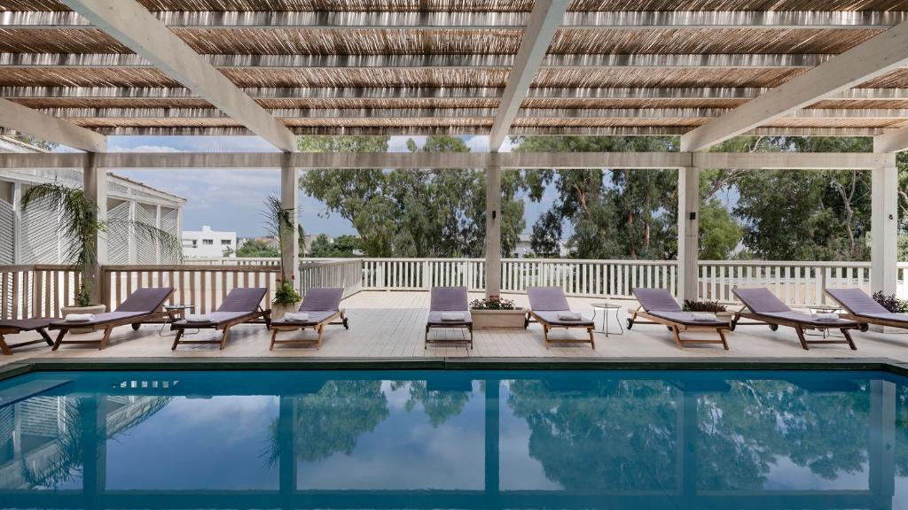 a patio with chairs and a swimming pool at Jacob Nea in Shave Ẕiyyon