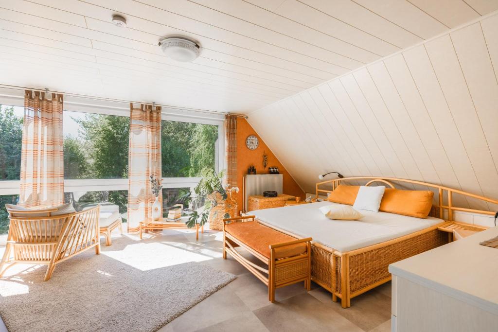 a bedroom with a bed in a room with windows at Appartement auf dem Land in Neuenkirchen