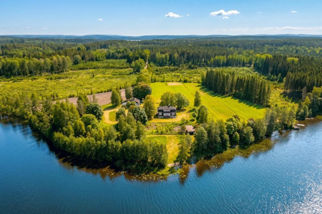 an aerial view of a house on an island in the water at Stay North - Marjaniemi in Salo