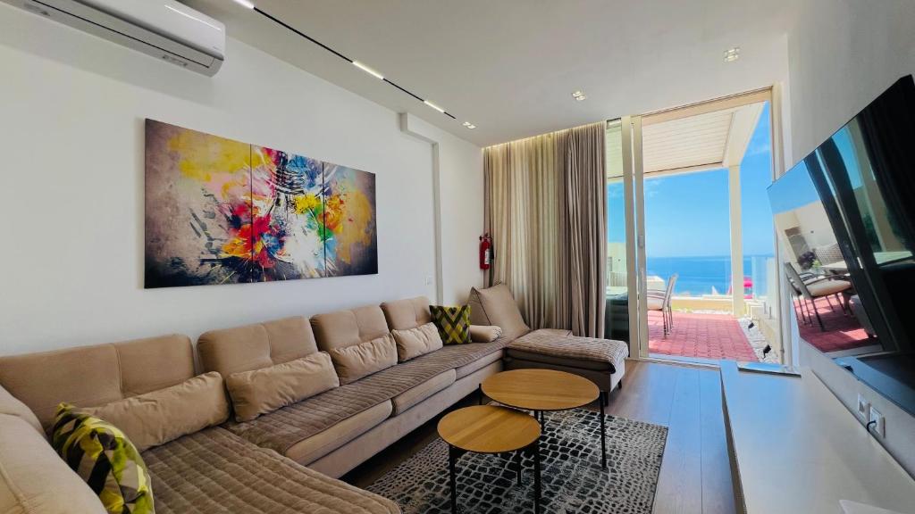 a living room with a couch and a table at Veranda Apartment, Green Coast in Palasë
