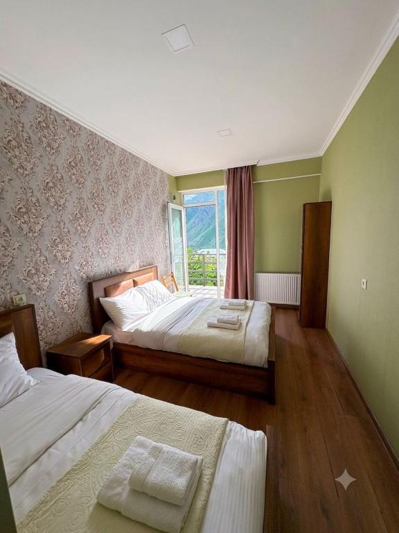 a hotel room with two beds and a window at Sky Star in Kazbegi