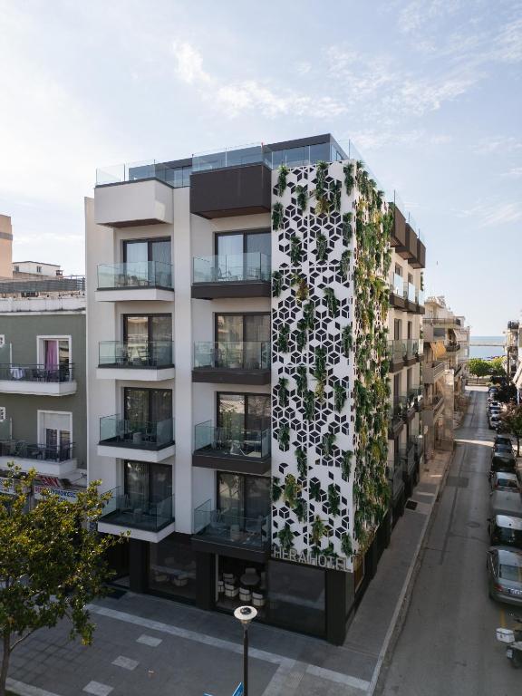 an apartment building with a vertical garden on the facade at Hera Hotel in Alexandroupoli