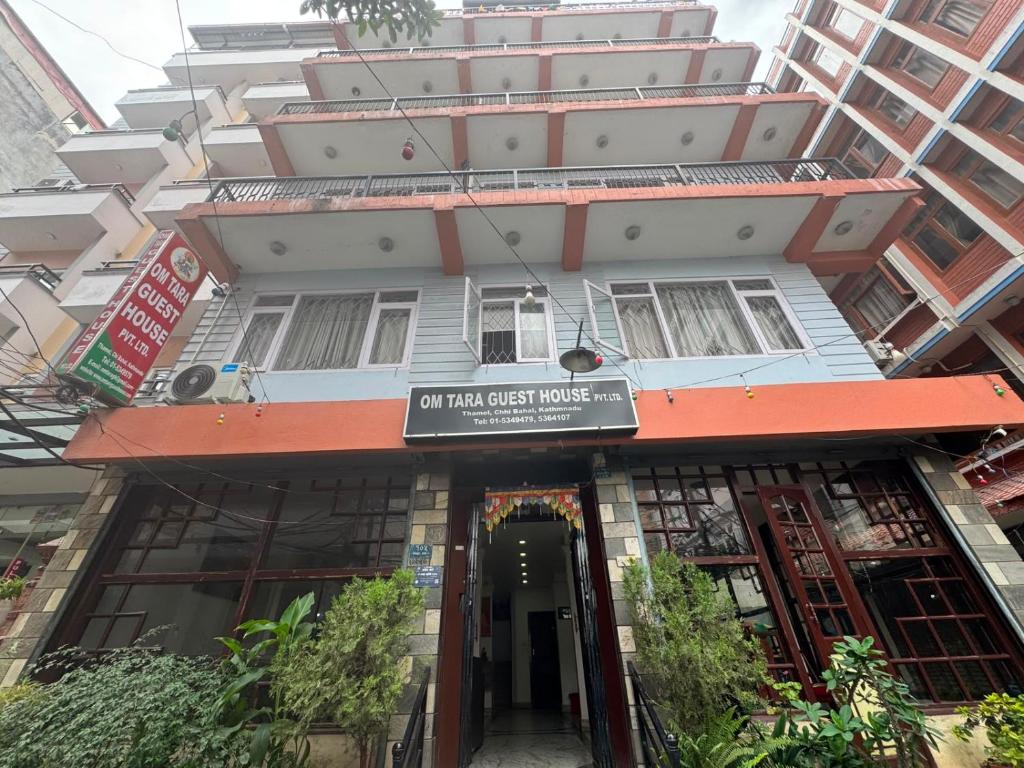 a building with a sign for a hotel guest house at Om Tara Guest House Pvt Ltd in Kathmandu