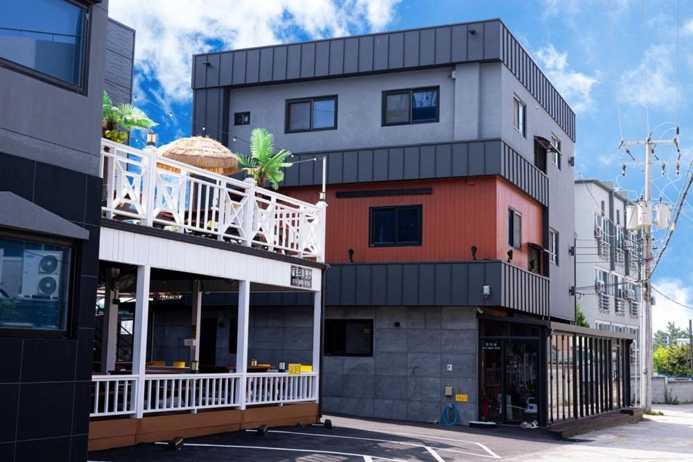 a building with a balcony on the side of it at Donghae Gloria Pension in Donghae