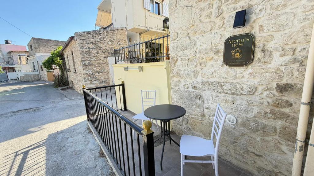 a table and chairs sitting outside of a building at Arena's nest in Áyioi Dhéka