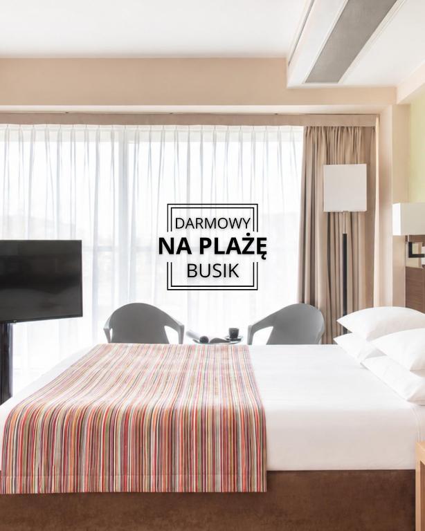 a hotel room with a bed and a tv at Hotel Arkon Park Gdańsk- Destigo Hotels in Gdańsk