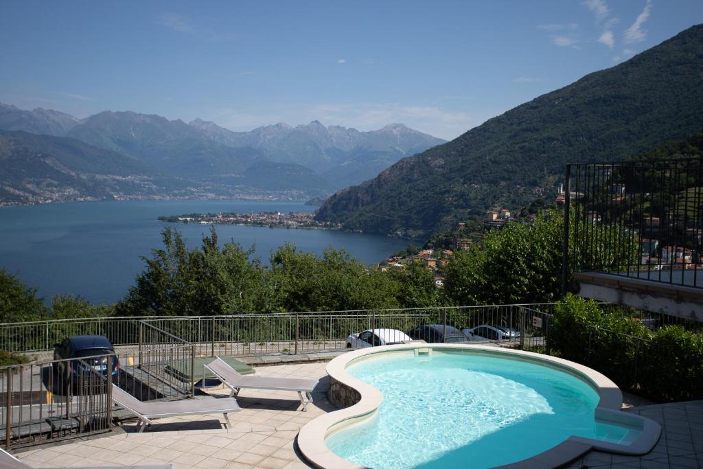 a swimming pool with a view of a lake and mountains at Casa Juliette in Bellano