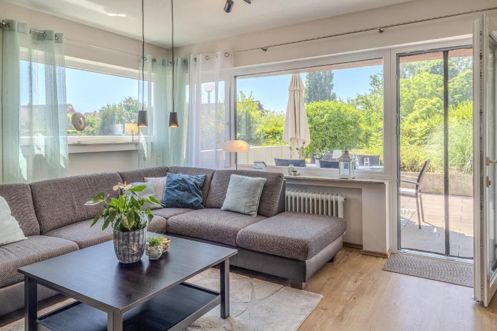 a living room with a couch and a table at Fewo Strandliebe in Gaienhofen