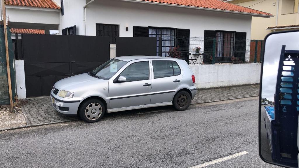 a small silver car parked on the side of a street at Casa Lena in Vagos