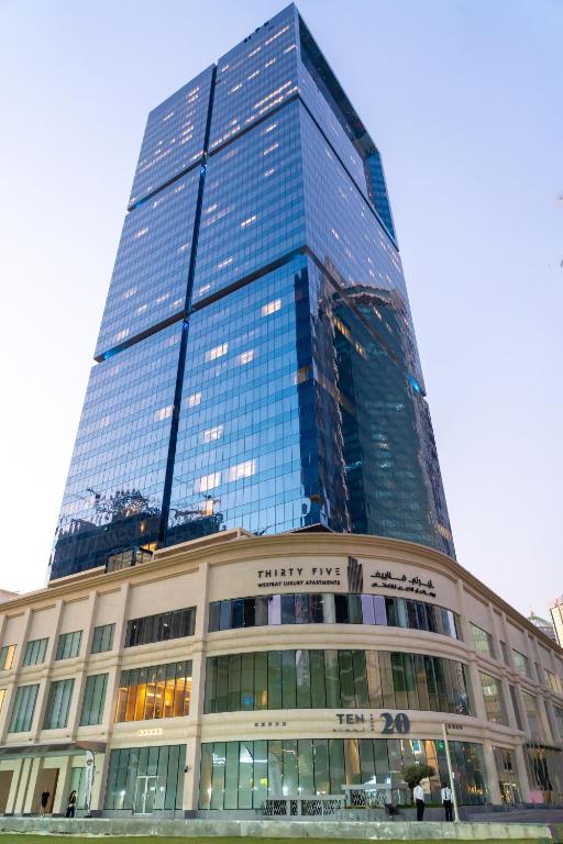 a tall building with a lot of windows at Thirty Five Westbay Luxury Apartments in Doha