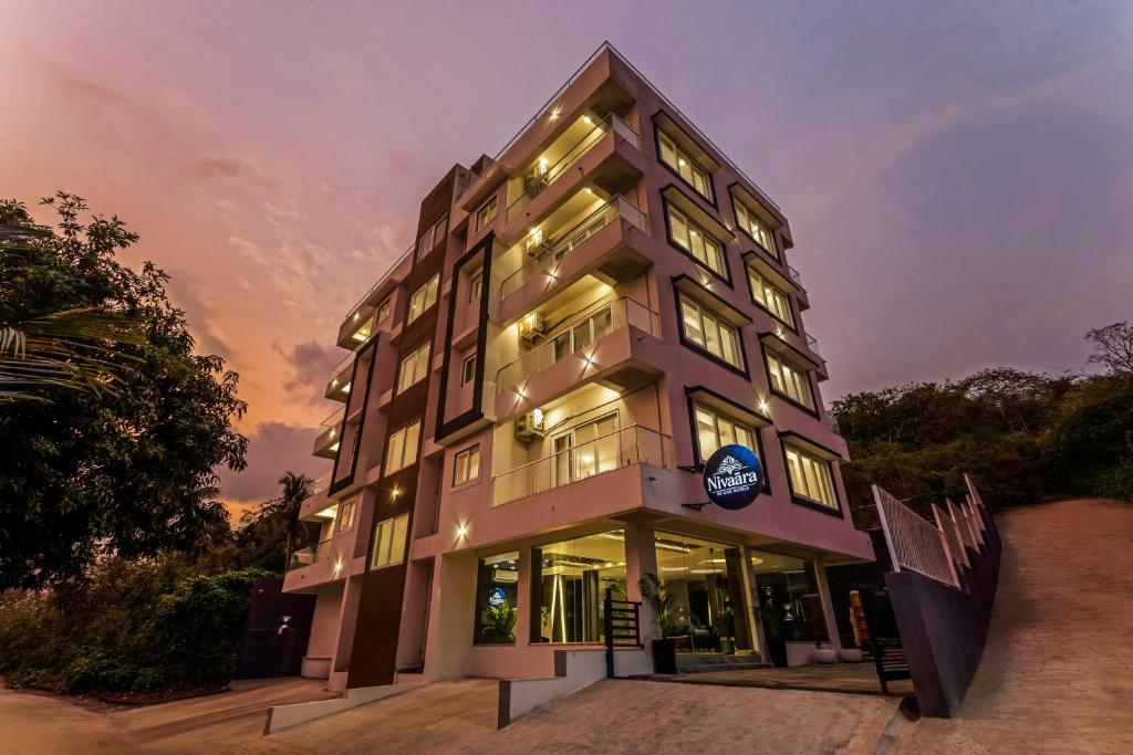 a tall building with a lot of windows at Nivaara by GHD Hotels in Nerul