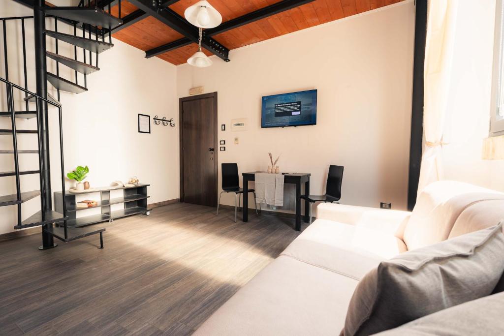 a living room with a white couch and a table at Residenza Michetti in Francavilla al Mare
