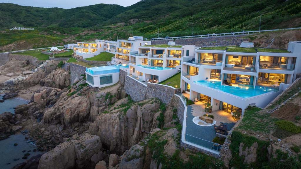 an aerial view of a house on a cliff at XIHUI Cliff Hotel in Tian'ao