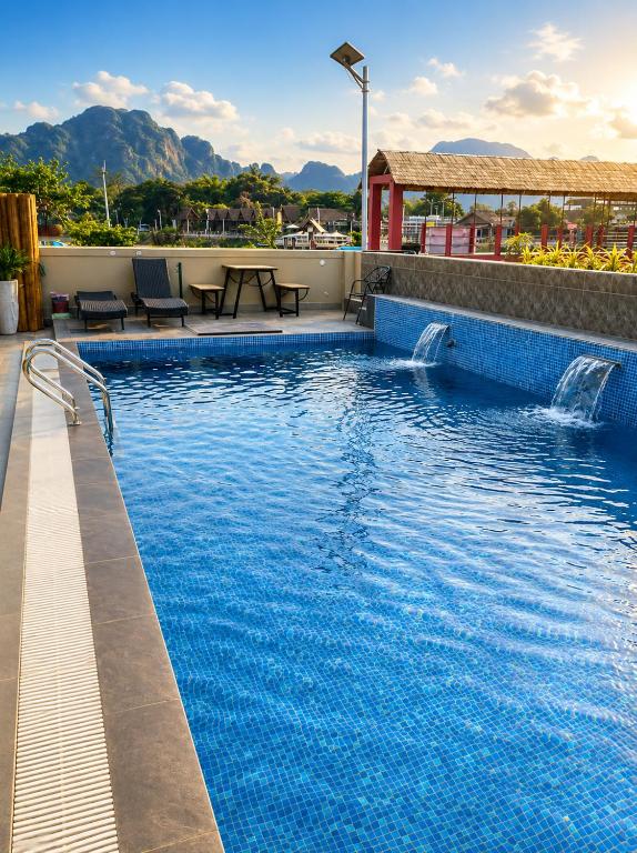 a swimming pool on top of a building at Tulip Elegant Riverside Hotel in Vang Vieng