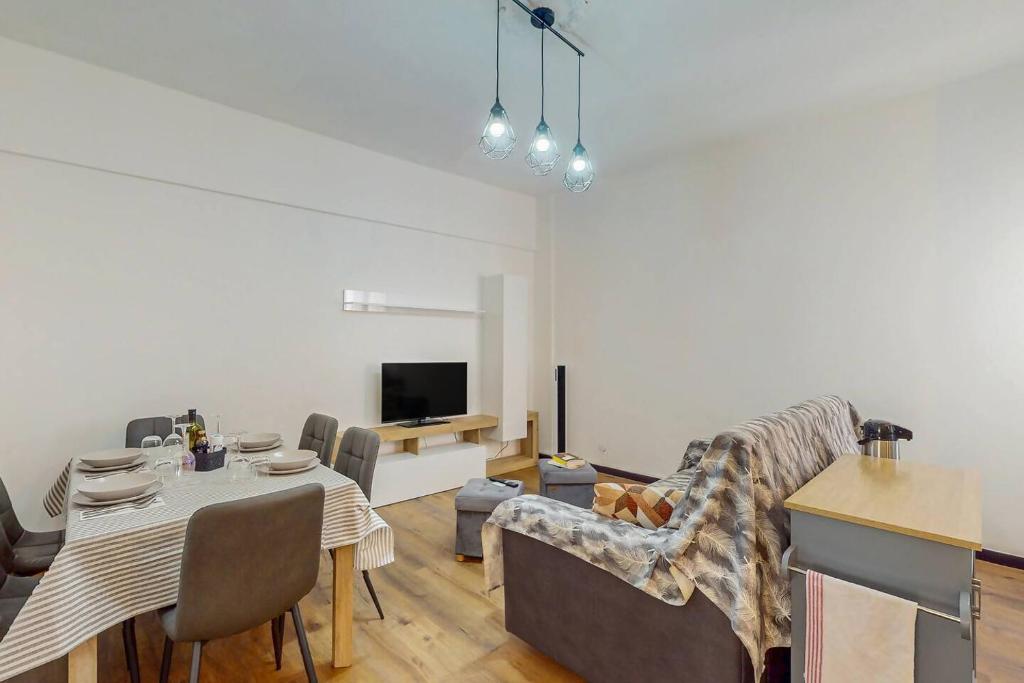 a living room with a table and a dining room at [DolciAcque] Dolce sosta nel cuore di Acqui in Acqui Terme