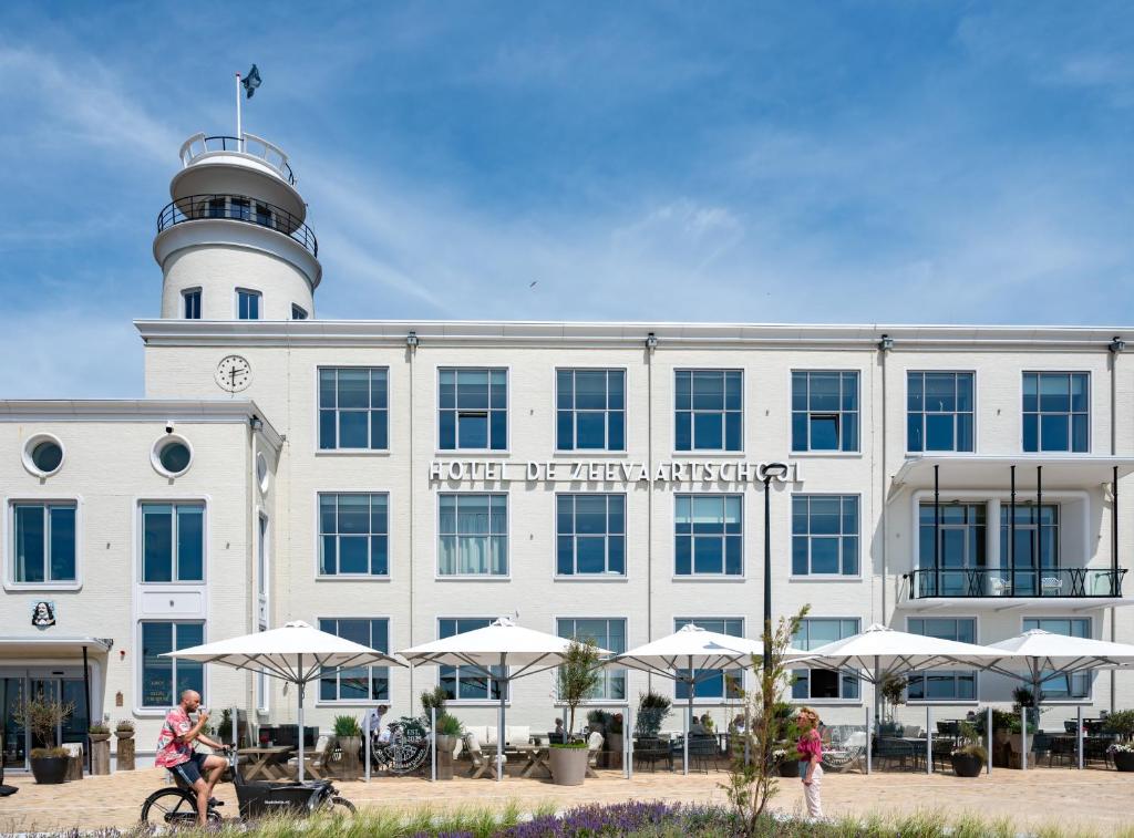 a building with a lighthouse on top of it at Hotel De Zeevaartschool in Vlissingen