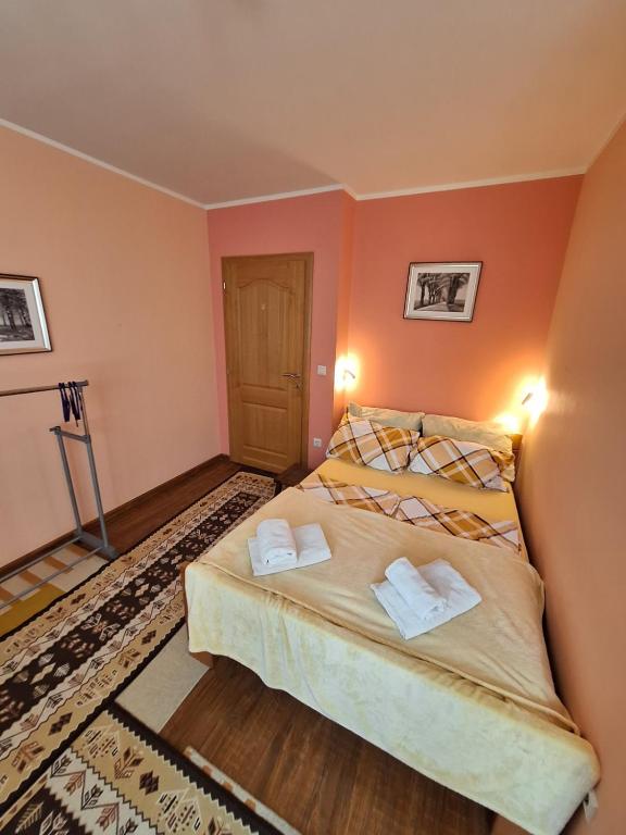 a bedroom with a bed with two pillows on it at Nensi in Mostar