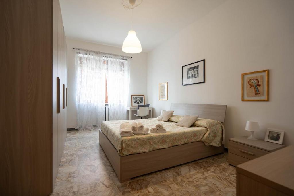 a bedroom with a large bed and a window at oasi bengasi in Moncalieri