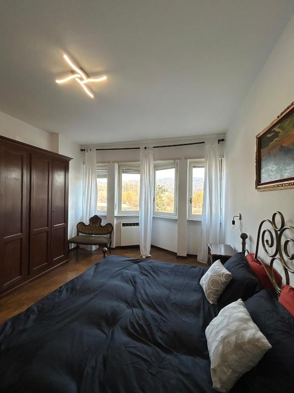 a bedroom with a large bed and a ceiling fan at 120 mq trilocale e terrazzo in Moncalieri